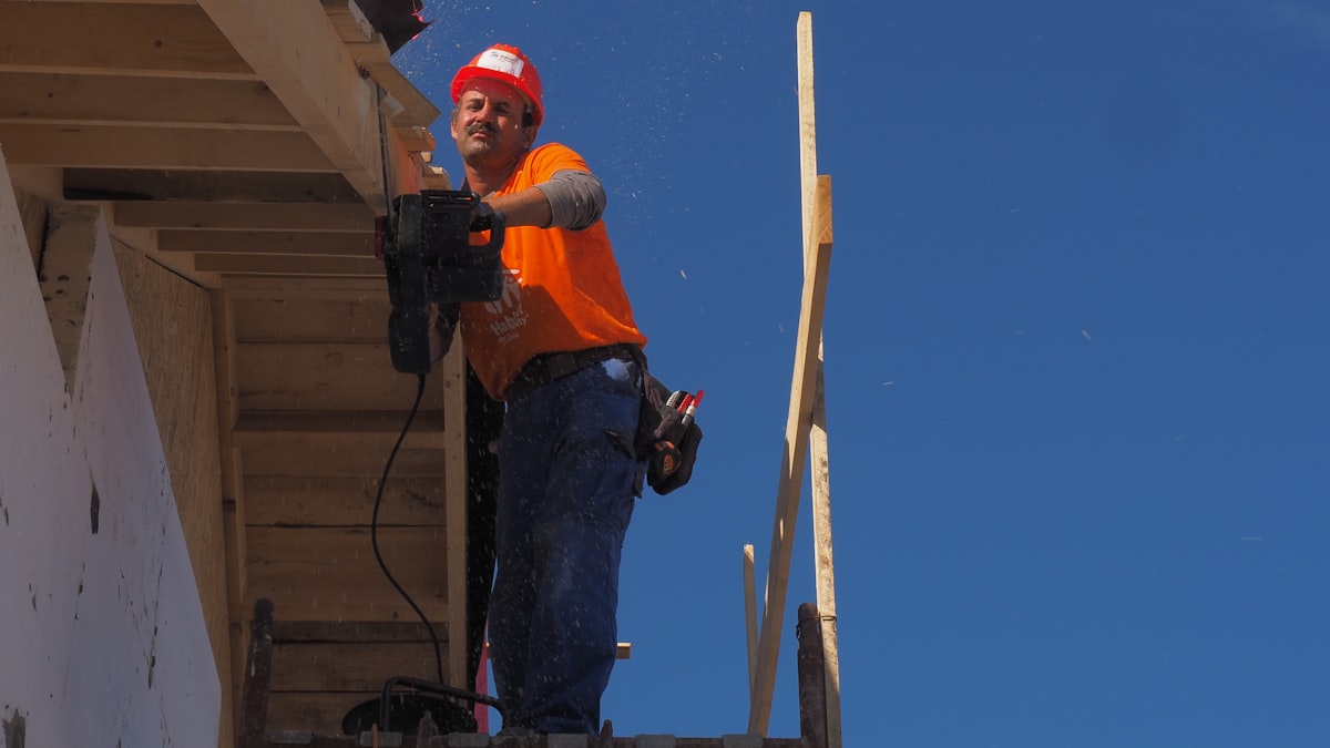 Ryan, founder of Peak Roofing Co., inspecting a roof installation
